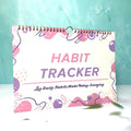 Habit tracking journal in four colour options showing 21cm × 28cm size