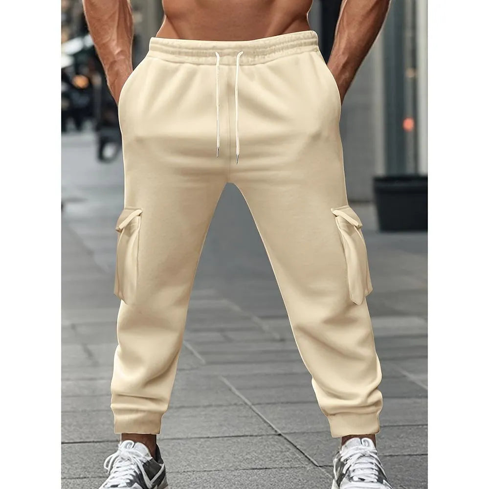 Men's solid colour casual multi-pocket drawstring sports pants in black, featuring polyester fabric and mid-waist design