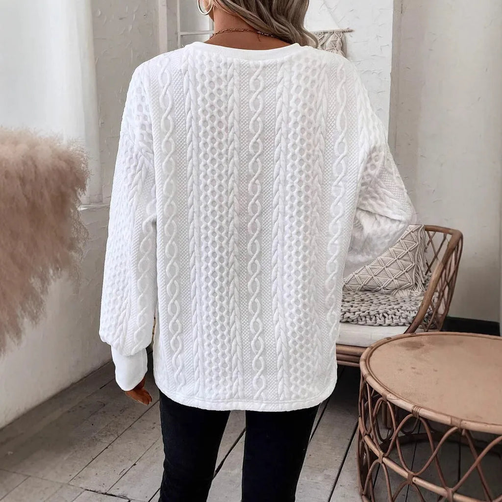 Milky white loose fit long sleeve T-shirt with a raised 3D pattern on the front.