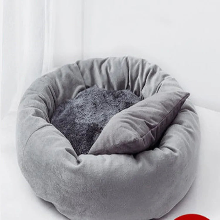 Light grey cotton-filled dog bed showing rounded shape and soft padding, with optional pillow beside it