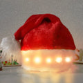 Red and white LED light up Santa hat with pom-pom, showing multicoloured twinkling lights on soft spandex material.