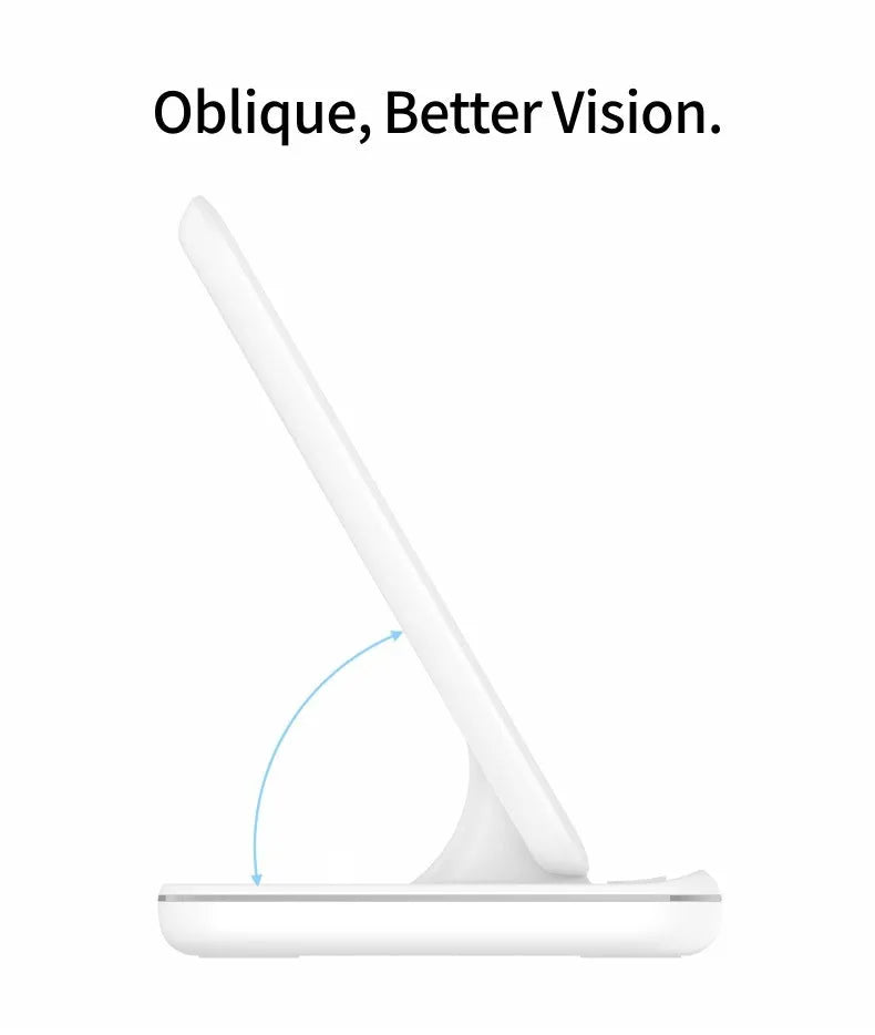 White three-in-one wireless charging stand holding a mobile phone, a smartwatch, and wireless earbuds on a desk.