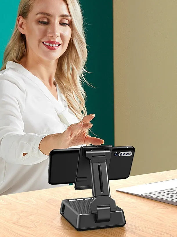 Black mobile phone smart broadcaster stand with Bluetooth speaker and HD mic on a desk