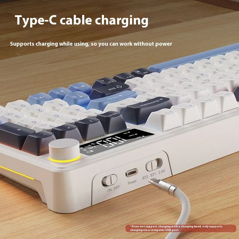 A blue and white two-tone wireless keyboard and mouse combo with mechanical-feel keys on a wooden desk.