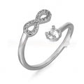 Gold metal open ring with diamond zircon letter design on a plain background