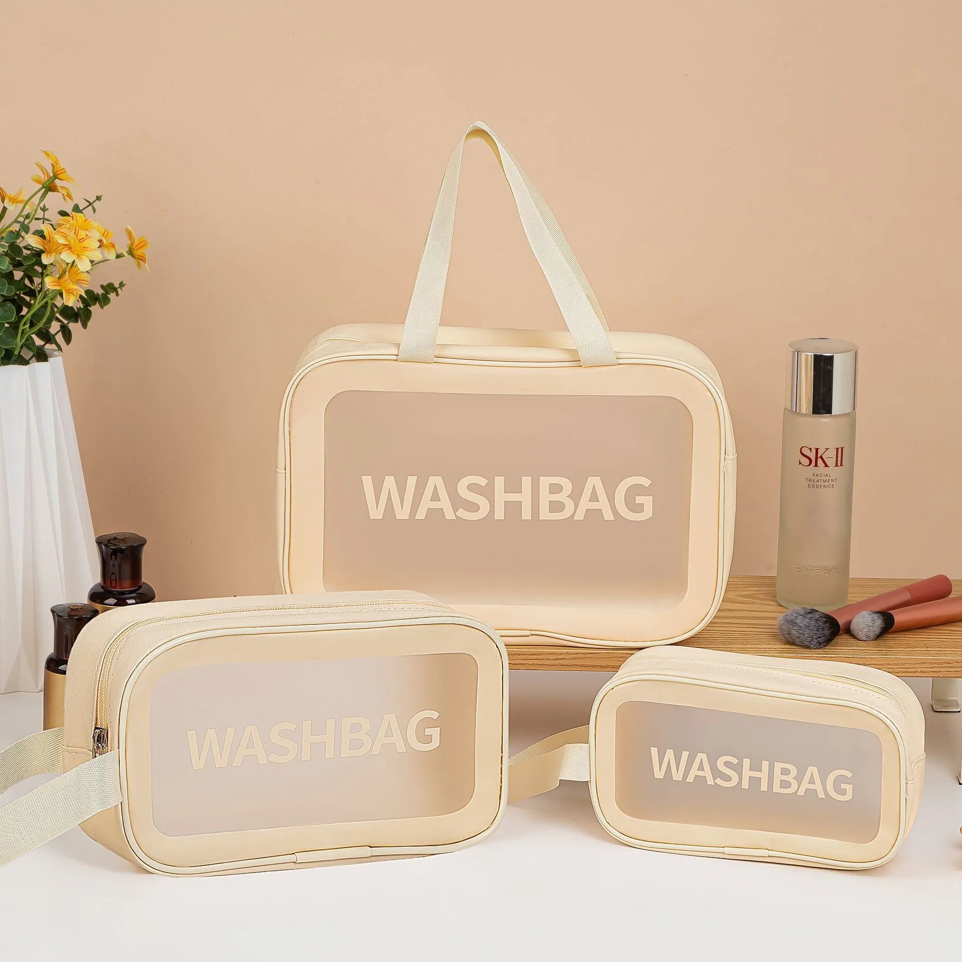 Large PVC transparent cosmetic bag three-piece set in various colours including beige, black, blue, pink, and white, empty and open on a flat surface