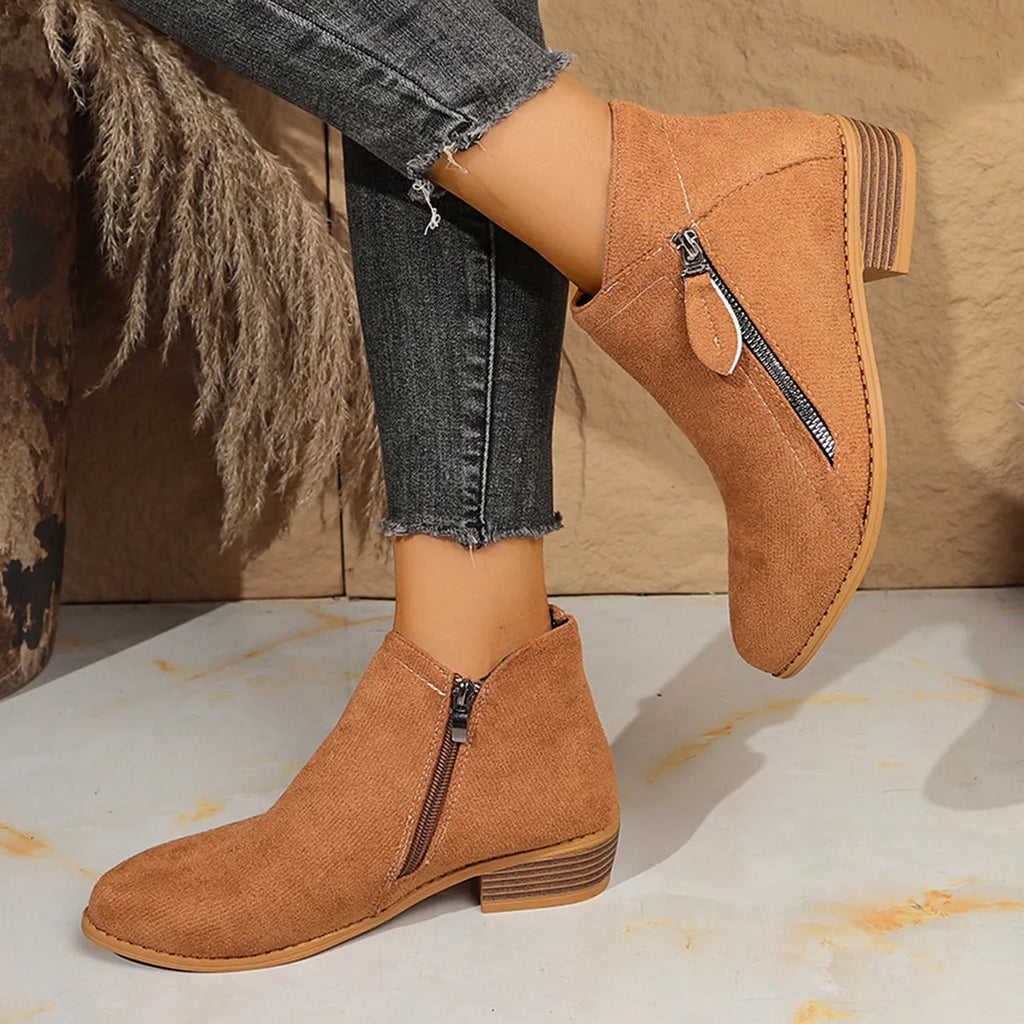 Suede women's ankle boots with side zipper in beige, shown on a white background