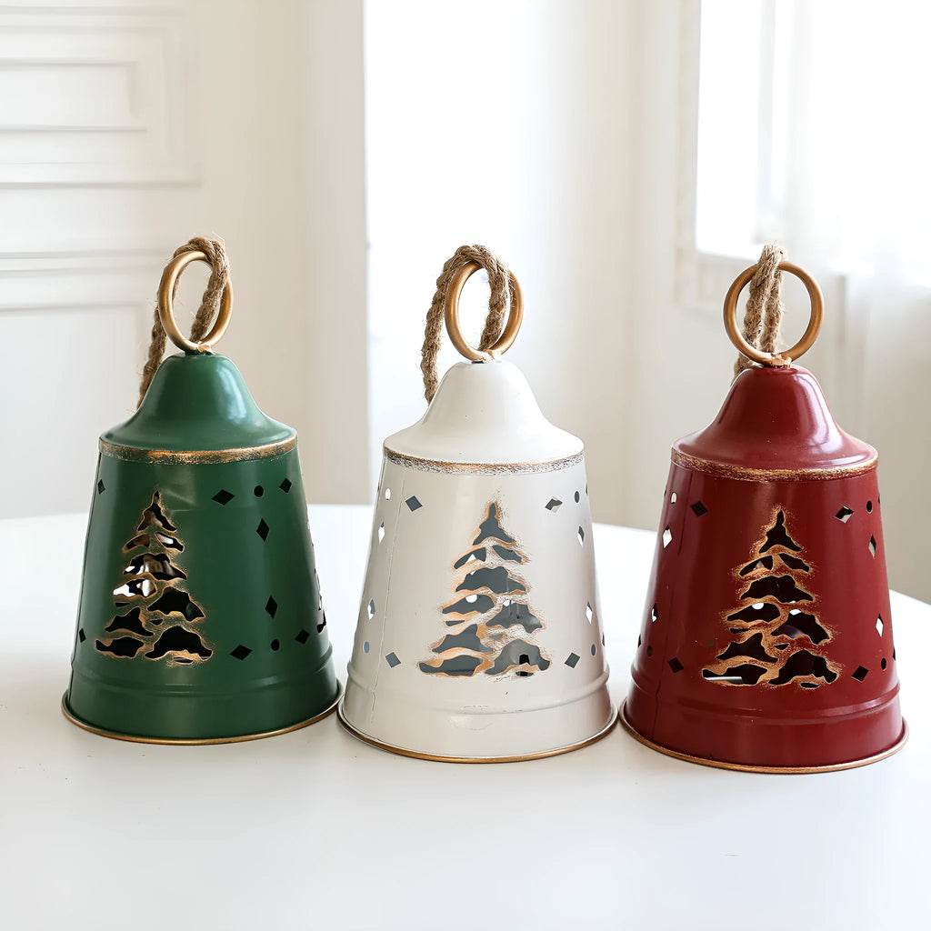 Wrought iron Christmas bell ornament in red, green, and white with hanging loop on a white background