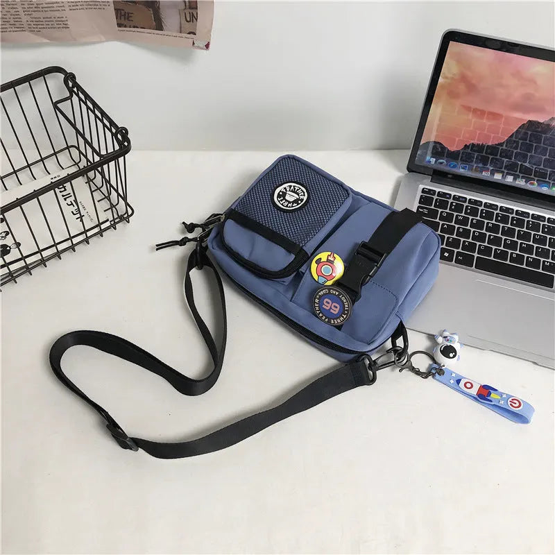 Casual nylon messenger bag for men women waterproof lightweight 22x6x17cm with badge pendants in beige black blue gray