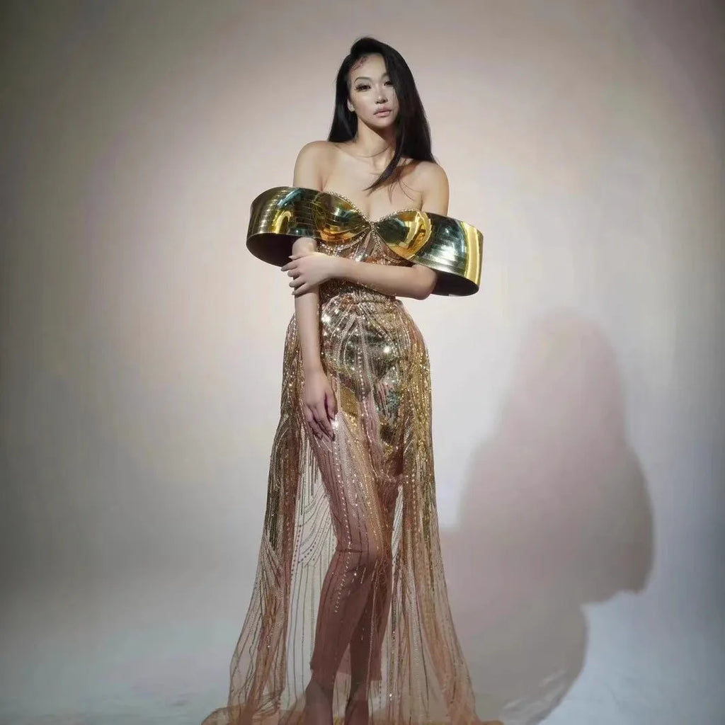 Gold metallic strapless dress with sequin details and a full tulle skirt featuring a high split.