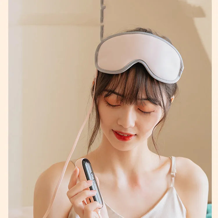 Portable eye spa massage goggles with suede exterior showing heat and vibration controls