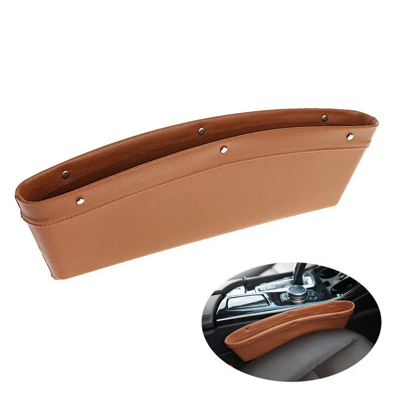 Faux leather car seat gap organiser in black holding phone, keys, and bills, fitted between car seat and centre console.
