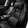 Memory foam car headrest and waist rest set in black leather and knitted fabric on a car seat