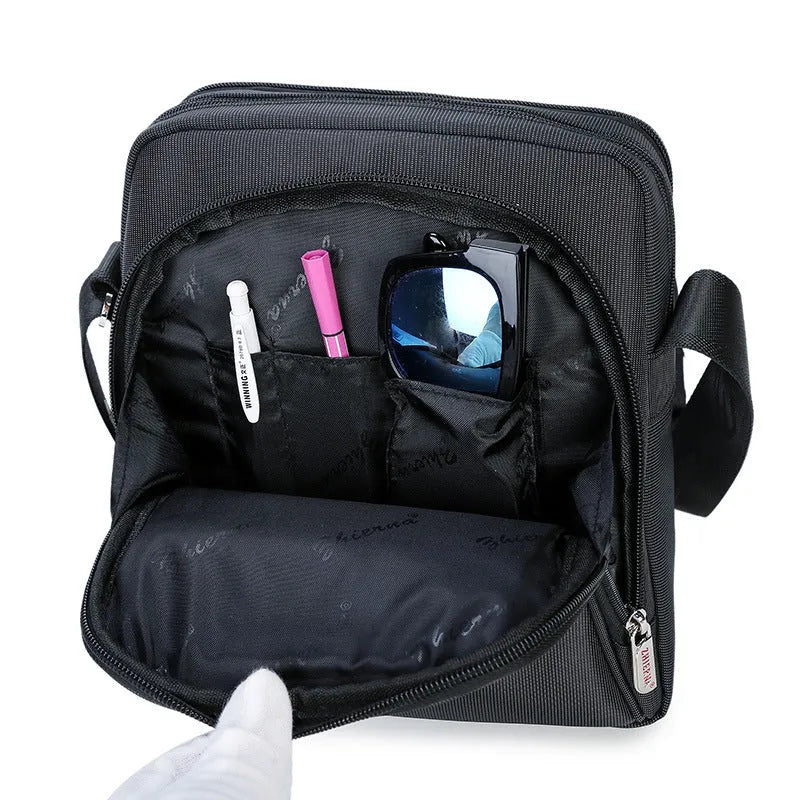 Men's black Oxford cloth messenger bag with zipper closure, single shoulder strap, and printed car-suture outer pocket