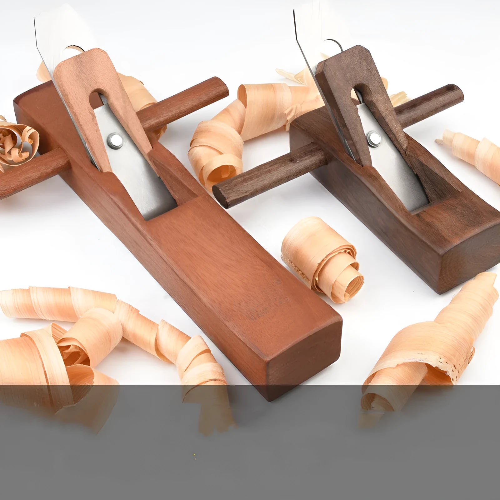 Six mahogany woodworking hand planes ranging from 95mm to 400mm on a wooden surface