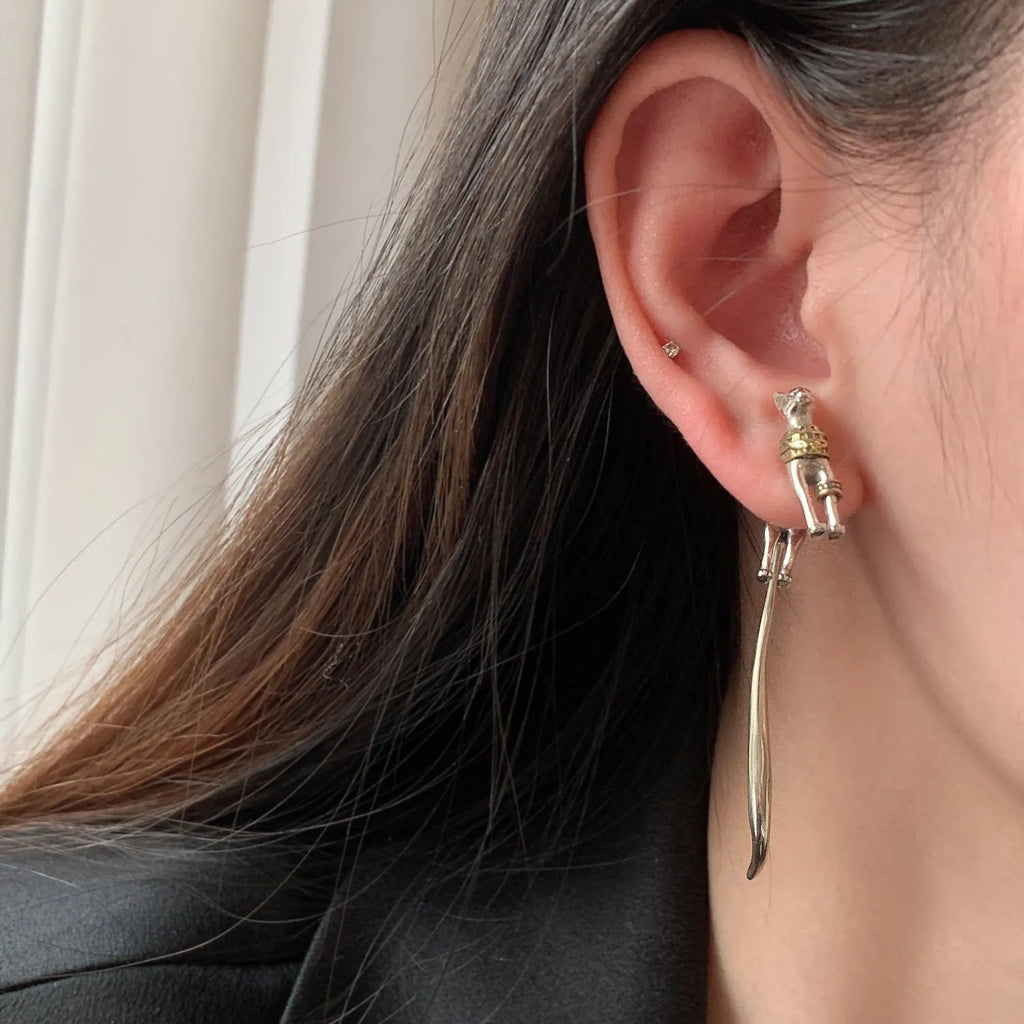 Single copper earring with pharaoh cat shape, gold and silver two-tone copper plated finish, colour separation design