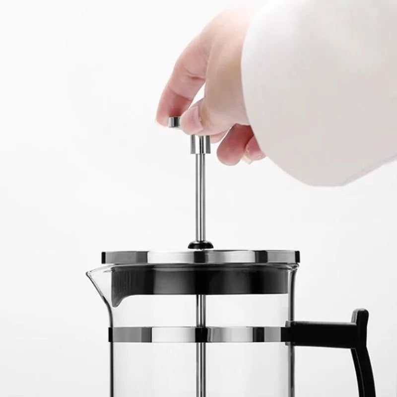 Manual pour-over coffee maker with glass carafe and stainless steel filter, 350ml capacity.