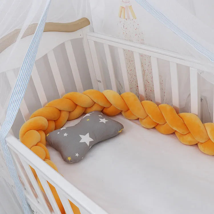 Baby cot bumper braid in spandex crystal velvet, shown in a light grey colour, wrapped around white crib rails.