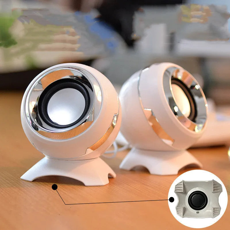 Compact black and gold desktop computer speakers with USB cable