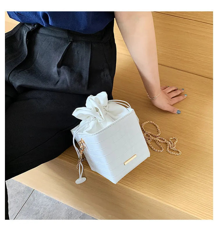 Korean-style small black PU bucket bag with a silver chain strap, shown open.