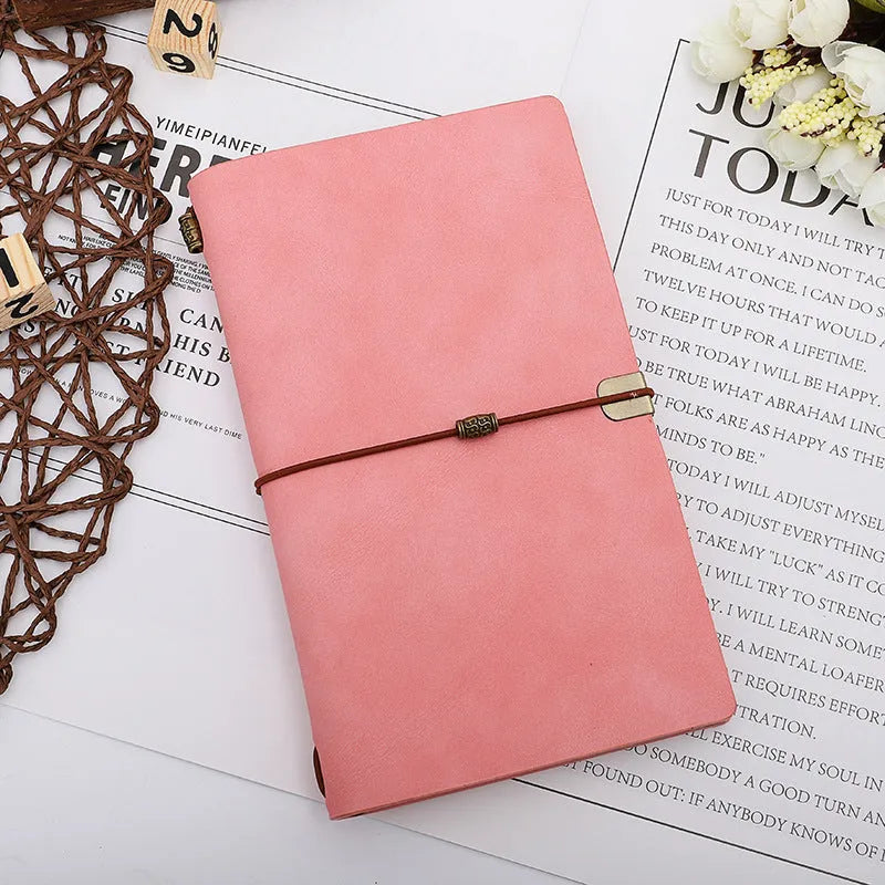 A6 imitation leather notebook with cowhide rope decoration, open to show flat-lying wireless binding.