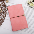 A6 imitation leather notebook with cowhide rope decoration, open to show flat-lying wireless binding.