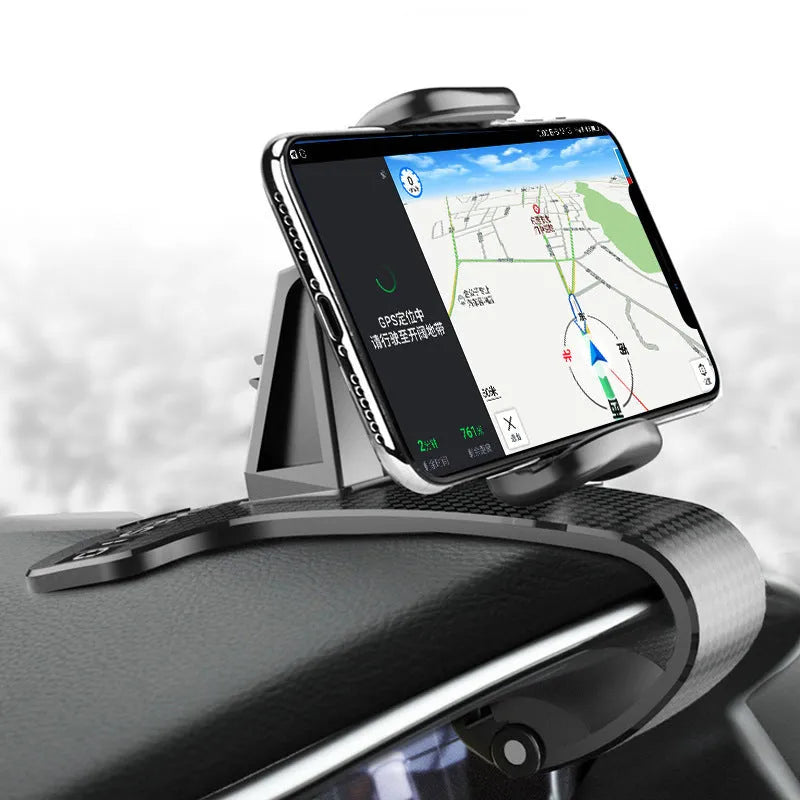 Black adjustable car phone holder with 360-degree rotating head on a car dashboard.