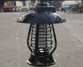 Black solar powered mosquito lamp with solar panel and LED lights for outdoor insect control