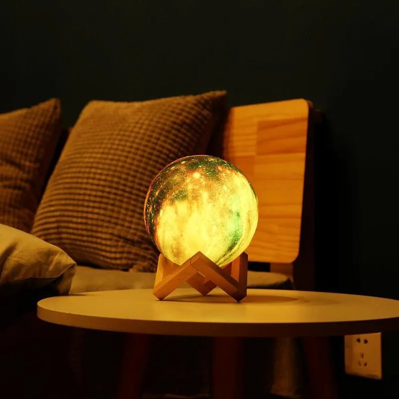 3D-printed sphere lunar night light on a base with a remote control.