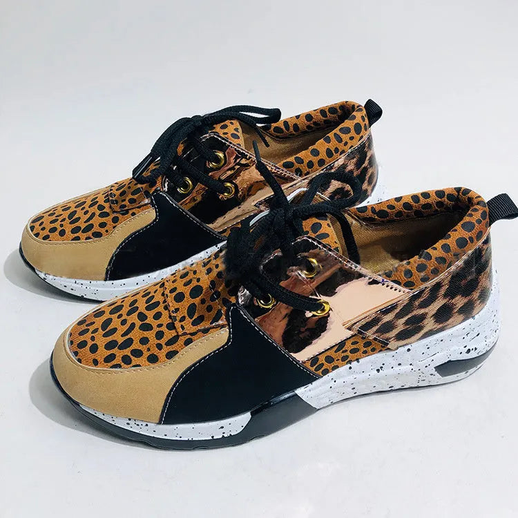 Women's casual suede sneakers with a wedge heel in black, leopard, pink, and snake pattern colours.