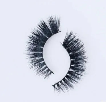 Pair of faux mink eyelashes with long tail and cotton stem against white background