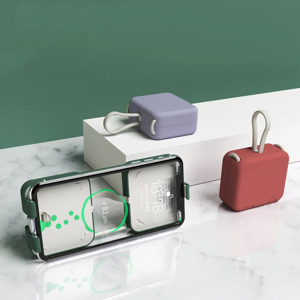 Handbag clip power bank in blue, green, red, or white showing phone stand function and charging ports