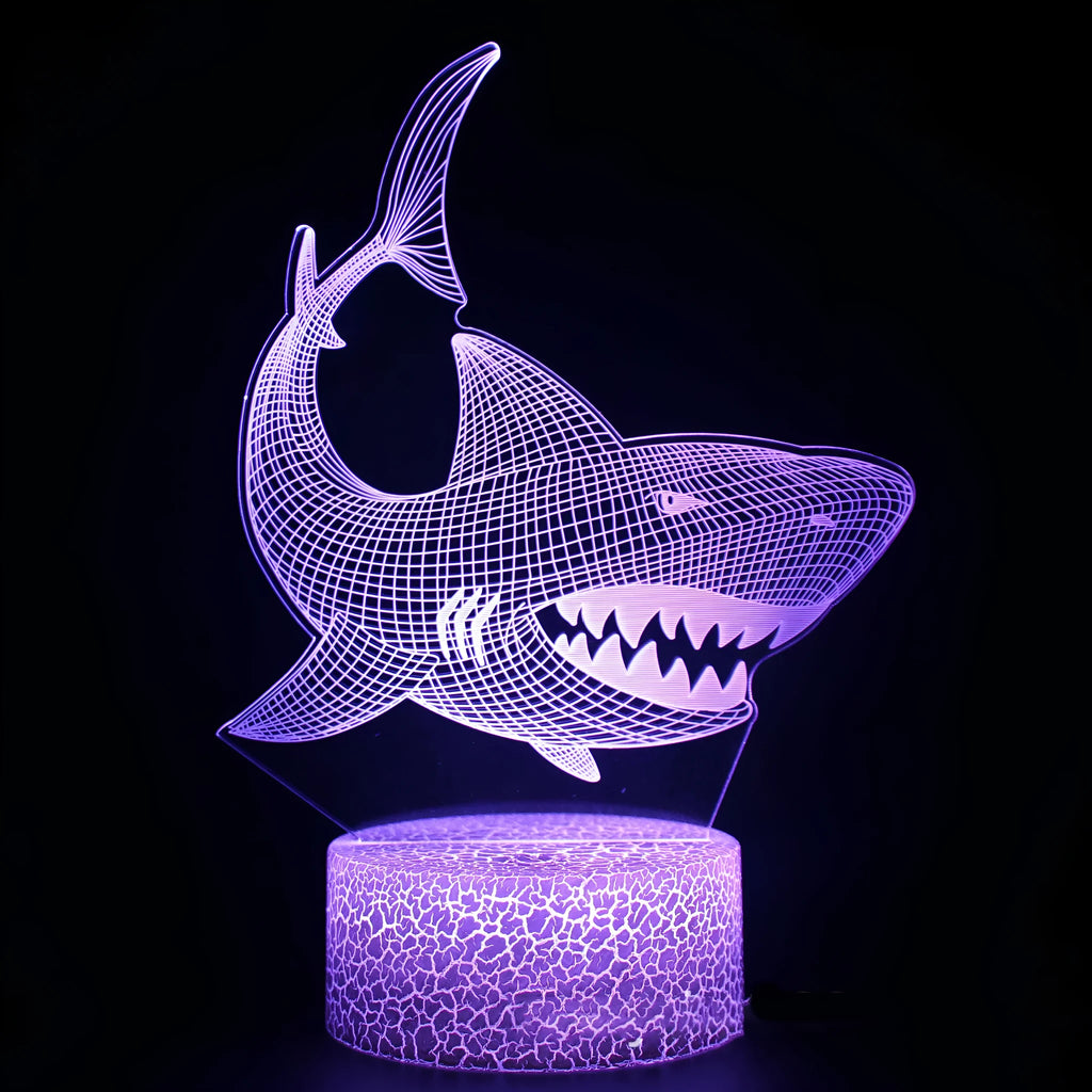 3D shark-shaped LED table lamp with colourful lighting and remote control on wooden surface