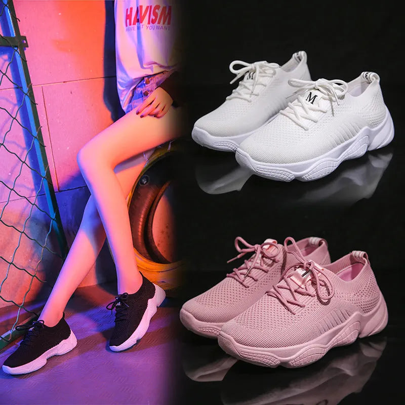 Women's white low-top woven sneakers with thick rubber sole and elastic front strap.