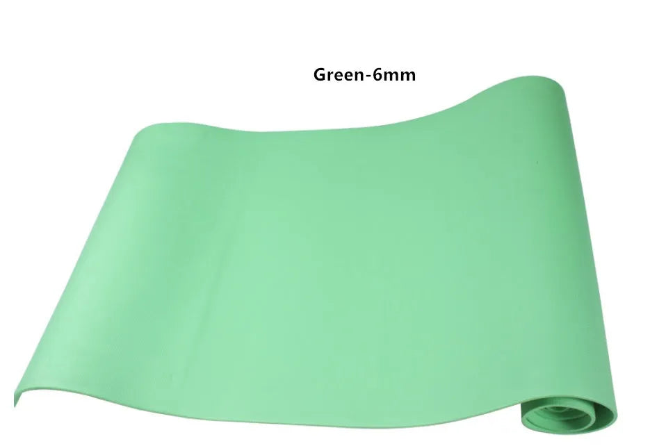 Red EVA fitness yoga mat with rolled edge showing thickness, laid flat on a wooden floor.