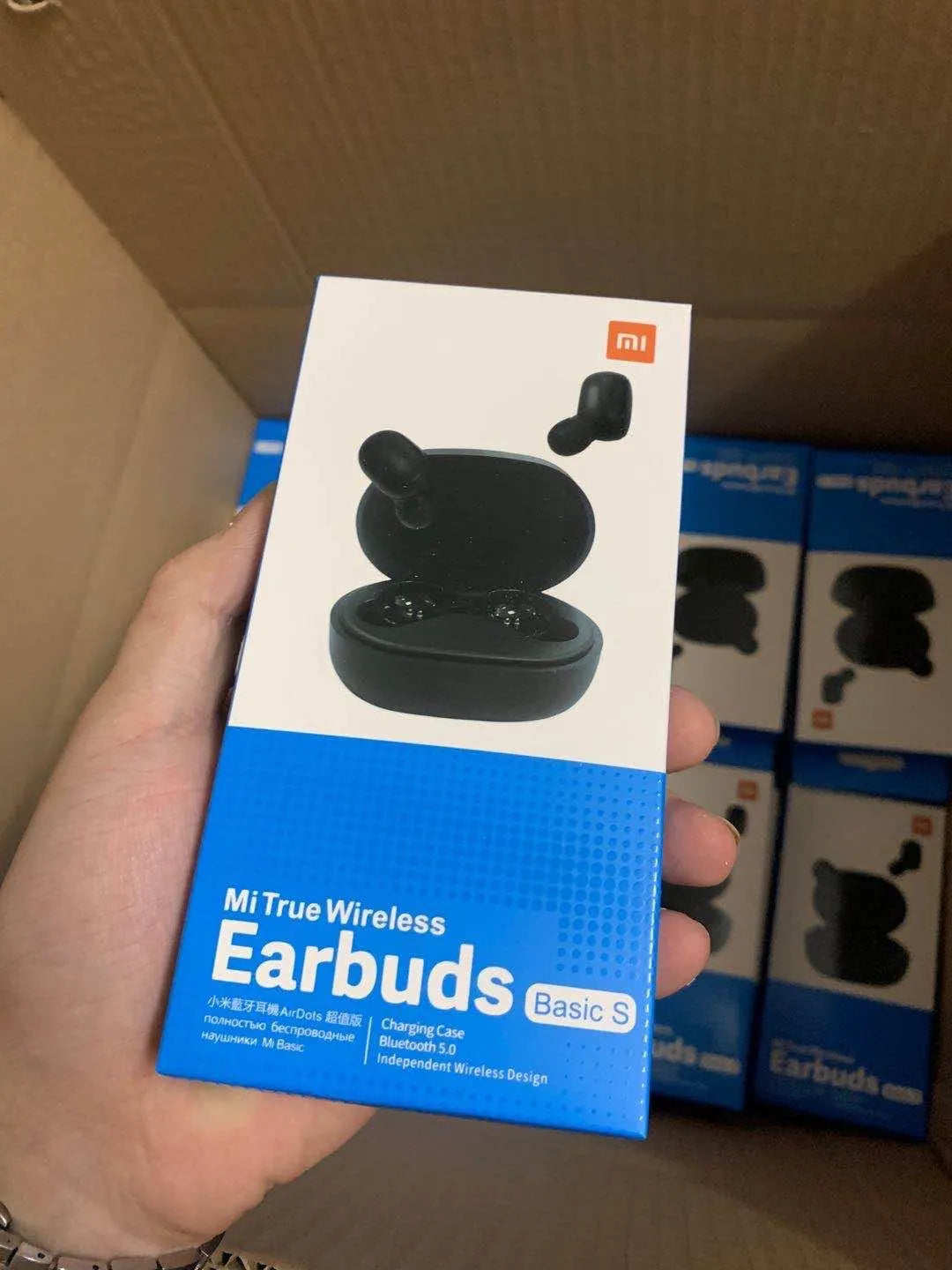 Redmi AirDots 2 black true wireless earbuds next to their compact charging case on a white background.