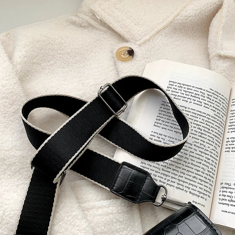 Vintage PU leather crossbody bag in black, shown with a mobile phone and wallet inside