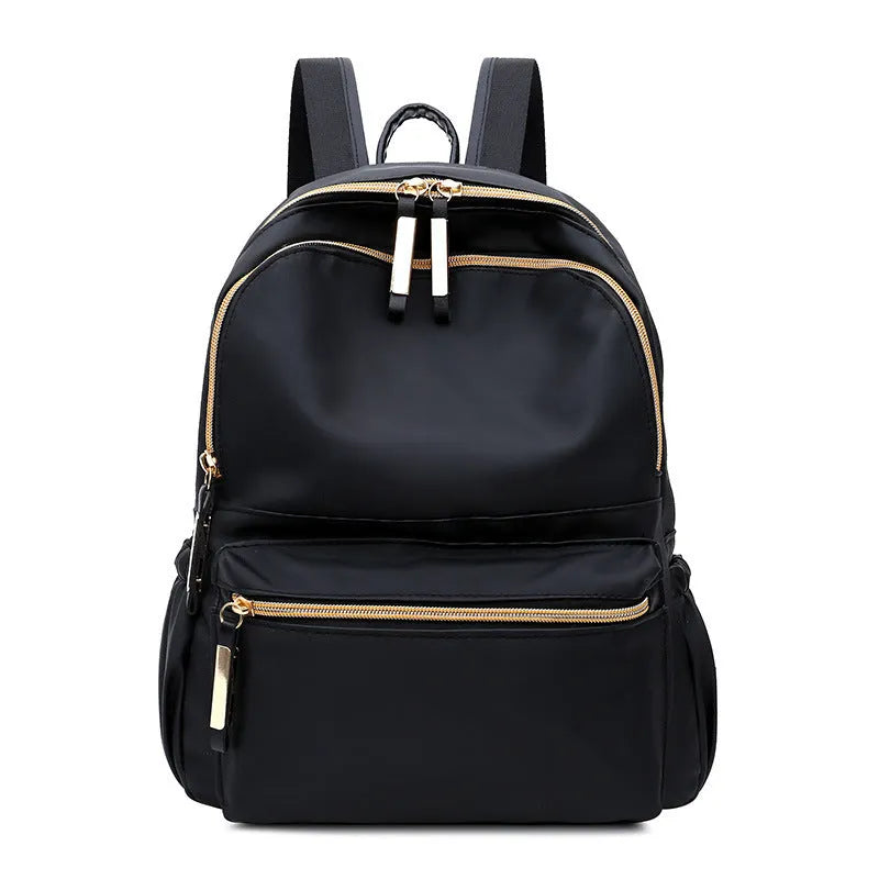 Black waterproof Oxford cloth backpack for women, 34x26x13cm, with two straps and front pocket on plain background