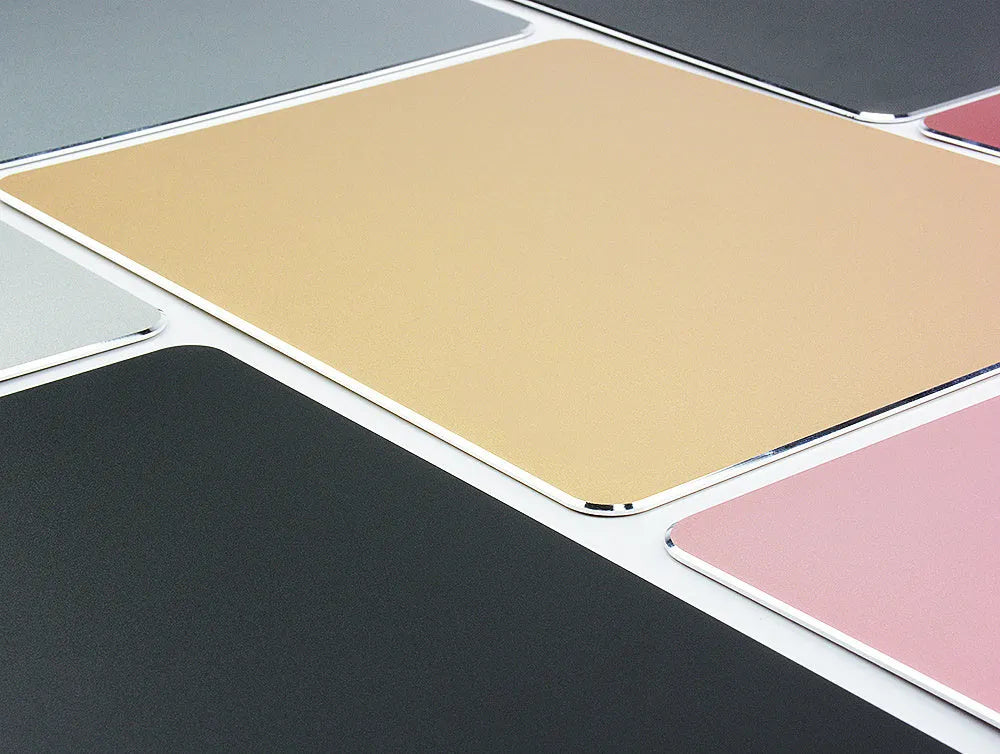 Aluminium alloy double-sided mouse pad in black finish on a desk for gaming or office use