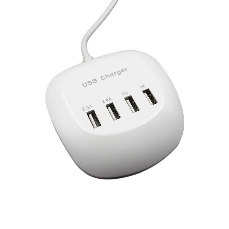 White dual USB wall charger with EU plug style next to smartphone and tablet