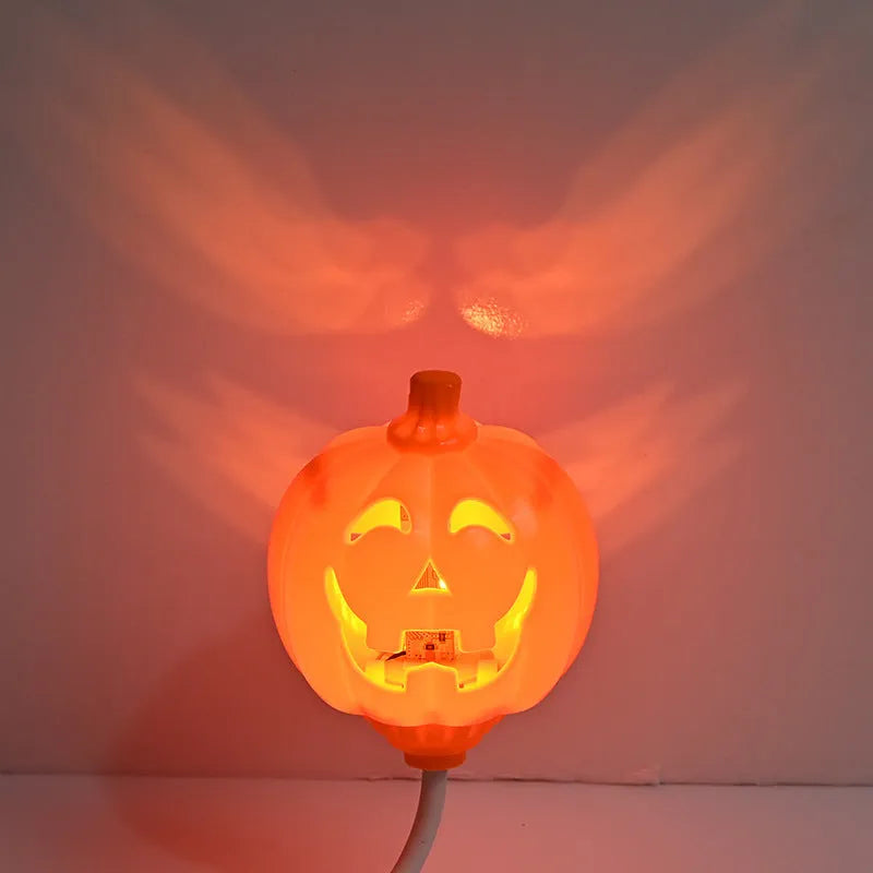 Plastic pumpkin-shaped lamp glowing with either purple or yellow light, measuring 22cm tall.