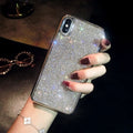 Silver silicone full diamond protective case for iPhone on a table.