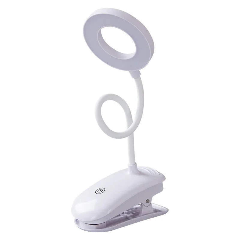 Modern clip-on rechargeable desk lamp with a white plastic shade and touch controls on its base.