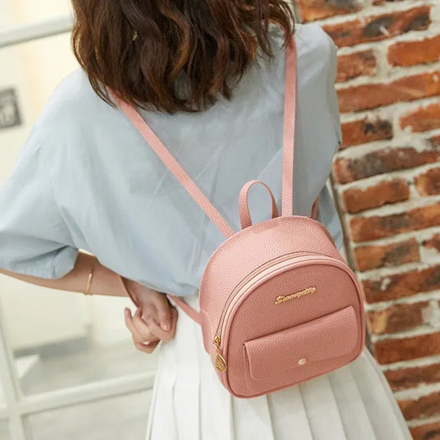 Women's small black PU shoulder backpack with a letter purse and zipper closure.