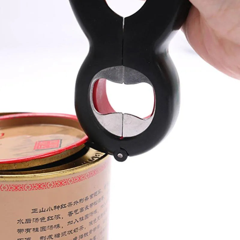 Six-in-one can opener in grey, ergonomic handle with stainless steel parts, on a kitchen counter