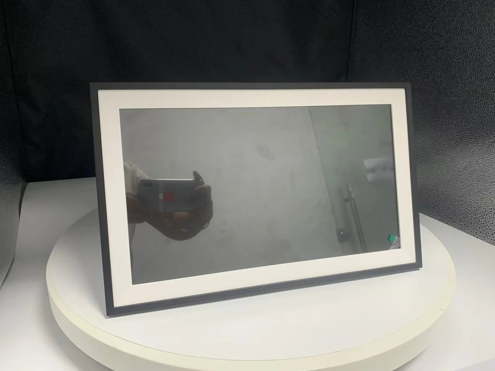 White 15.6 inch smart Wi-Fi digital photo frame with Full HD screen on a desk