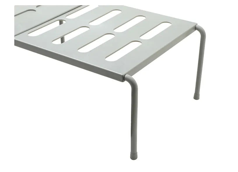 White telescopic kitchen rack with adjustable height showing extended and compressed positions
