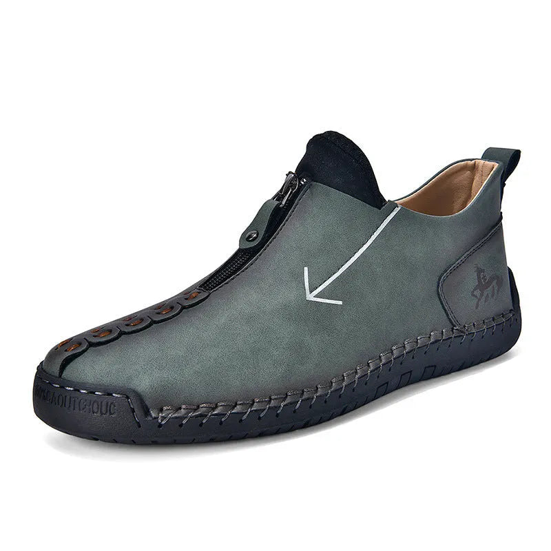 Men's black leather martin boots with a front zip, round toe, and hand-stitched seams on a rubber sole.