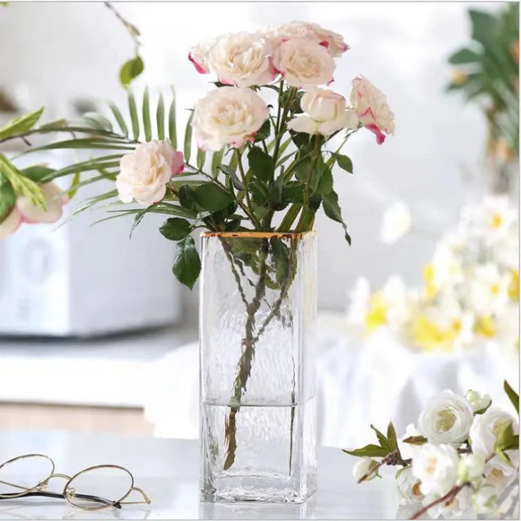 Transparent gold-painted glass vase on table with flower stems, 8x30cm size