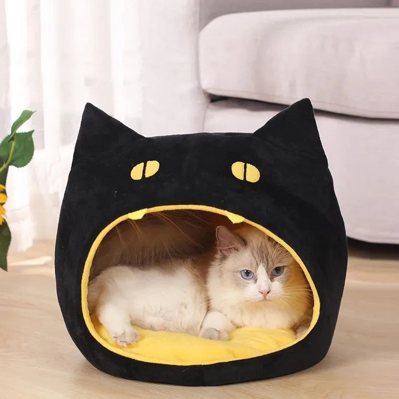 Grey cat-shaped covered pet bed with a removable cushion, shown on a wooden floor.